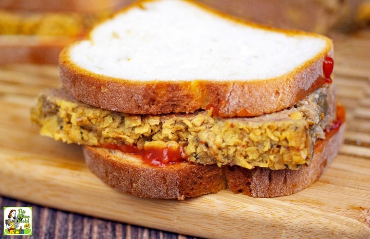 A leftover meatloaf sandwich on a wooden cutting board.