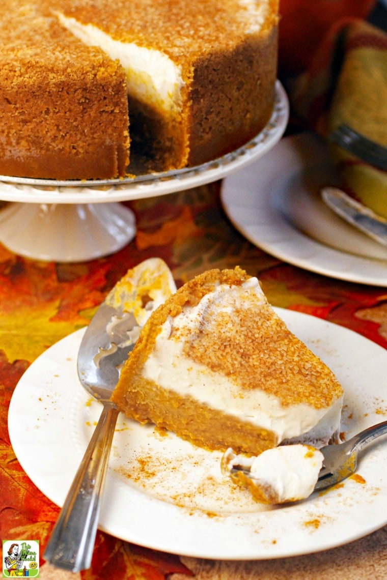 A slice of dairy free pumpkin pie on a white plate with serving knife and fork.