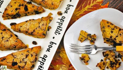 A plate and plate of gluten free scones with pumpkin, raisins, and chocolate chips.