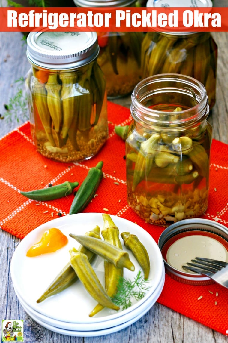 Mason jars and a plate of pickled okra on an orange napkin.