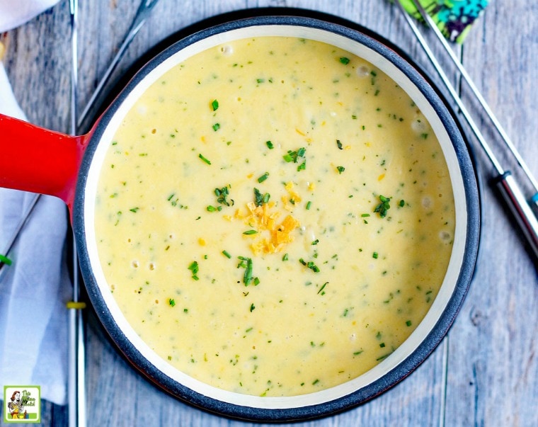 Overhead view of a pot of Brie & Chive Fondue with fondue forks.