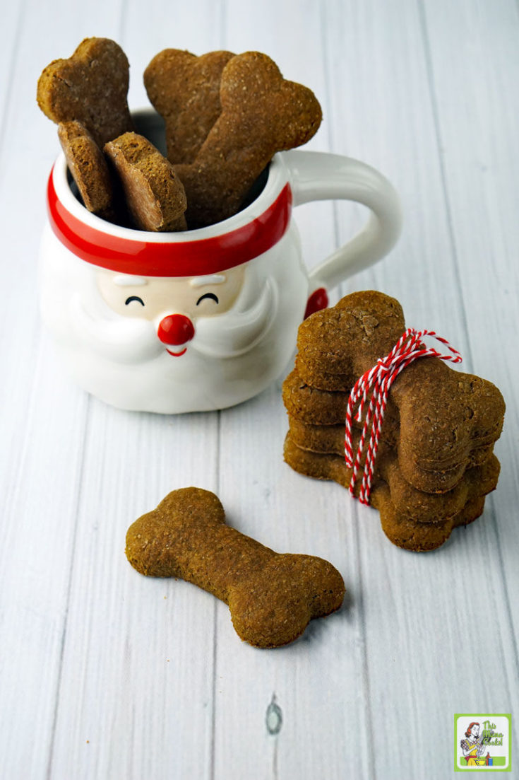 Homemade Dog Treats in a Santa mug and wrapped in red string.