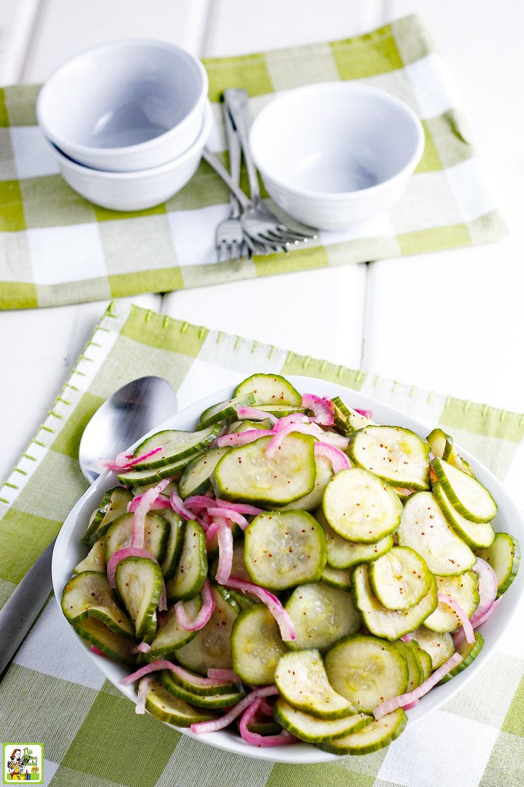 A bowl of Cucumber Onion Salad with serving spoon and napkin.