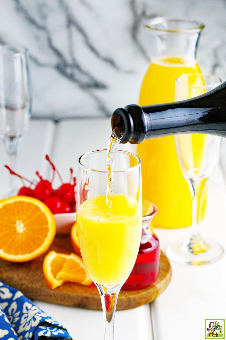 Making Prosecco Mimosas. Pouring sparkling wine or champagne into a glass. 