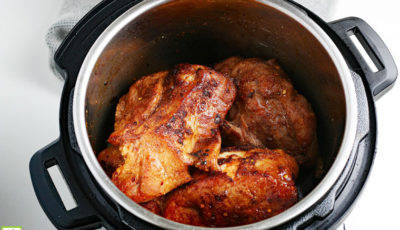 Open Instant Pot with pieces of pork.