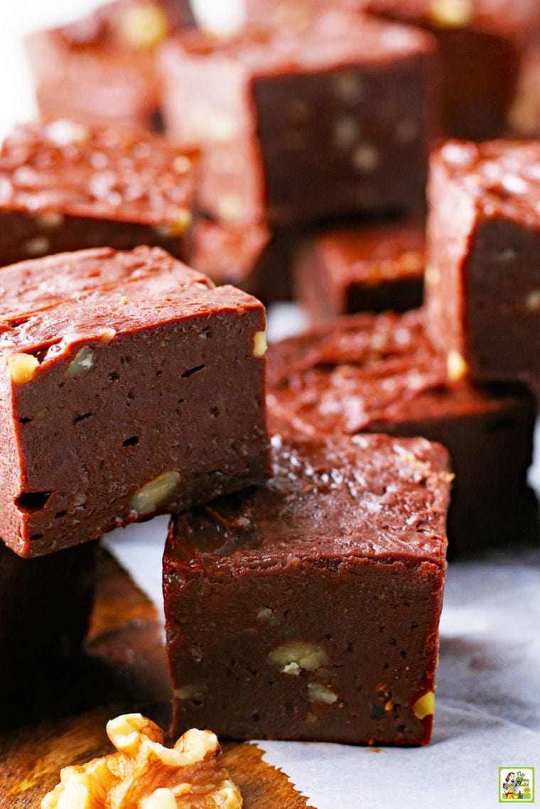 Pieces of chocolate and nut fudge on parchment paper.