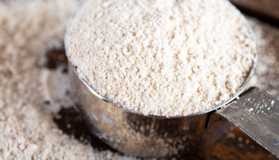 Metal measuring cup of flour.